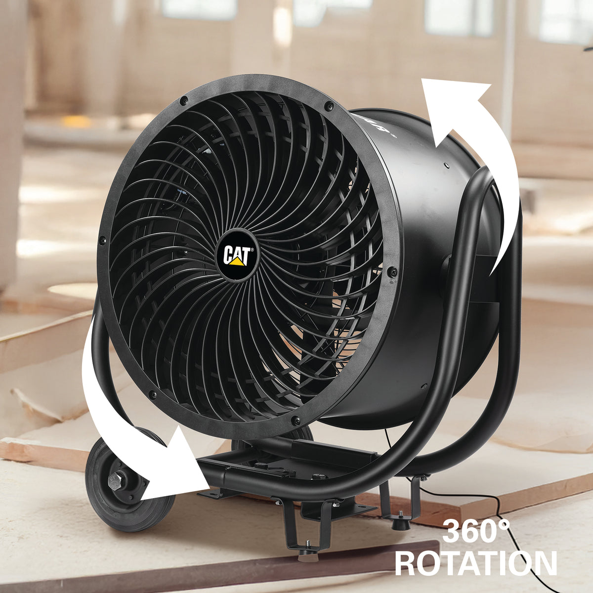 A large black CAT industrial blower fan with white arrows showing 360° rotation, photographed in a workshop-like setting.
