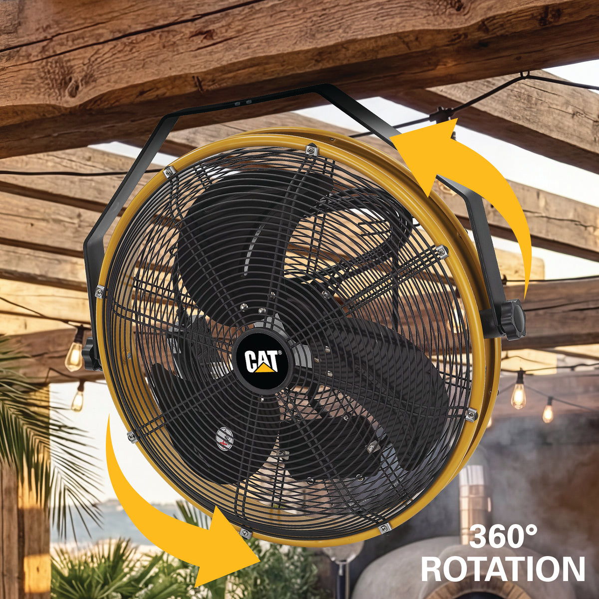 A large yellow CAT industrial ceiling fan shown hanging under a wooden pergola, with yellow arrows indicating 360° rotation and text reading '360° ROTATION'.