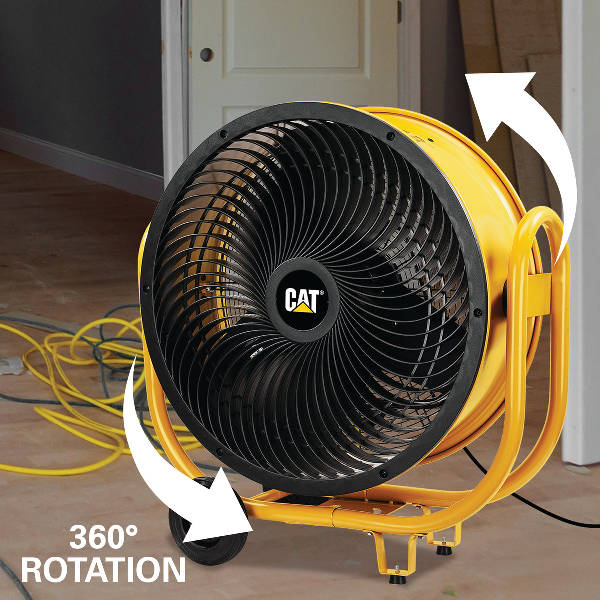 Yellow CAT industrial fan with white arrows showing 360-degree rotation, photographed indoors near a door and floor cords.